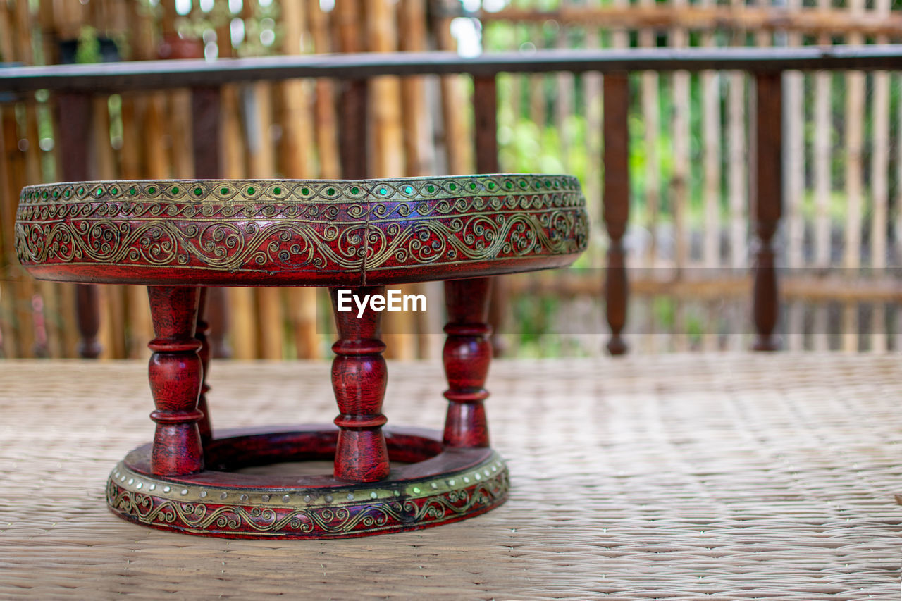 focus on foreground, no people, wood, architecture, furniture, table, pattern, day, seat, outdoors, religion, history, built structure, iron