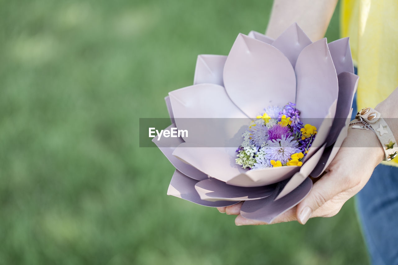 Midsection of woman with flowers