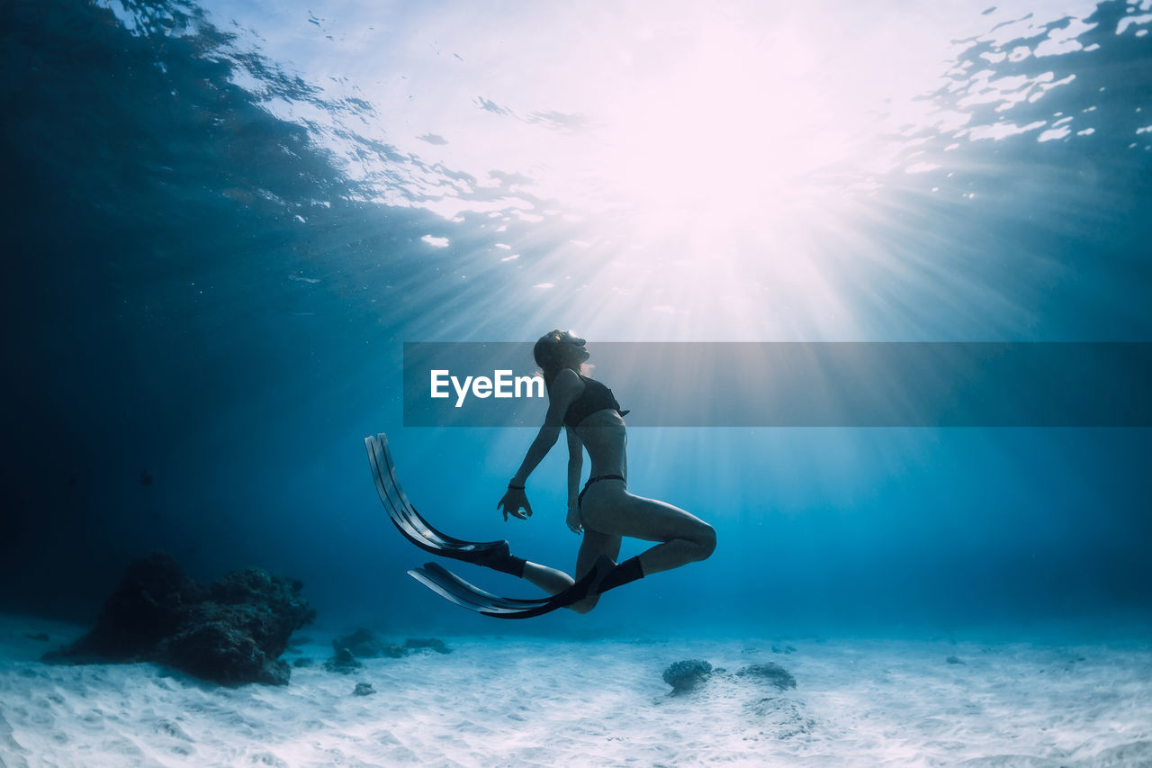 low angle view of woman swimming in sea