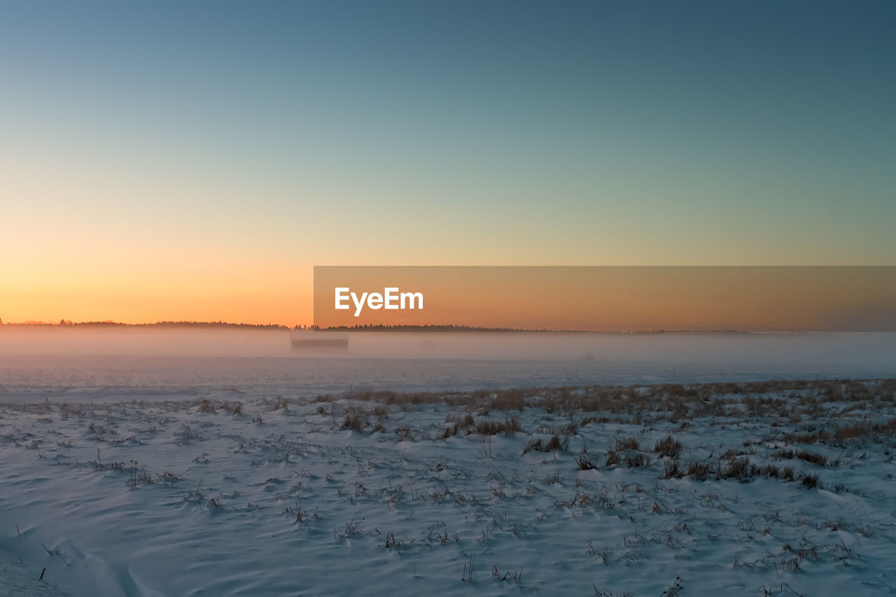 Scenic view of sea against clear sky during sunset