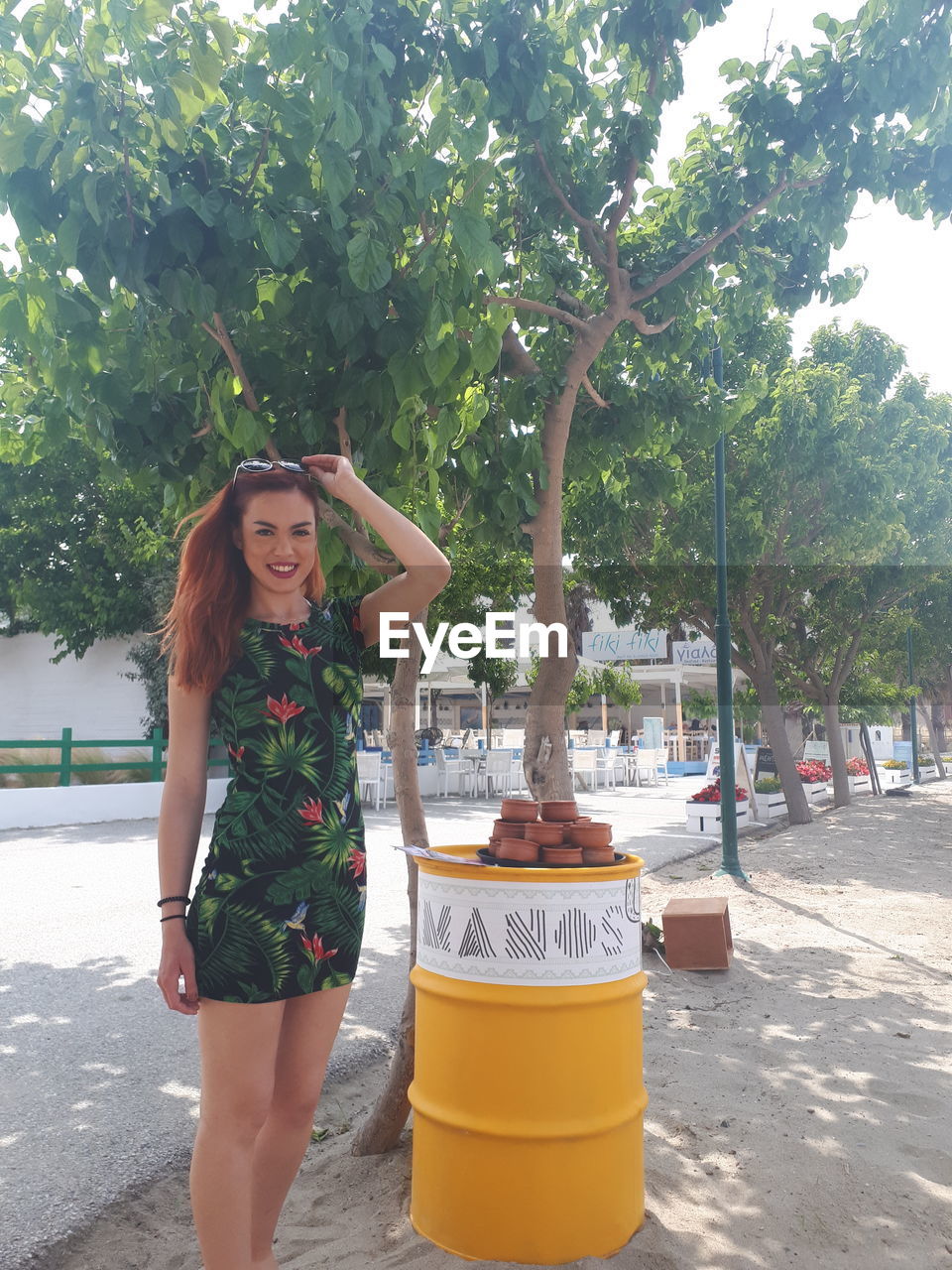 Portrait of woman standing against trees