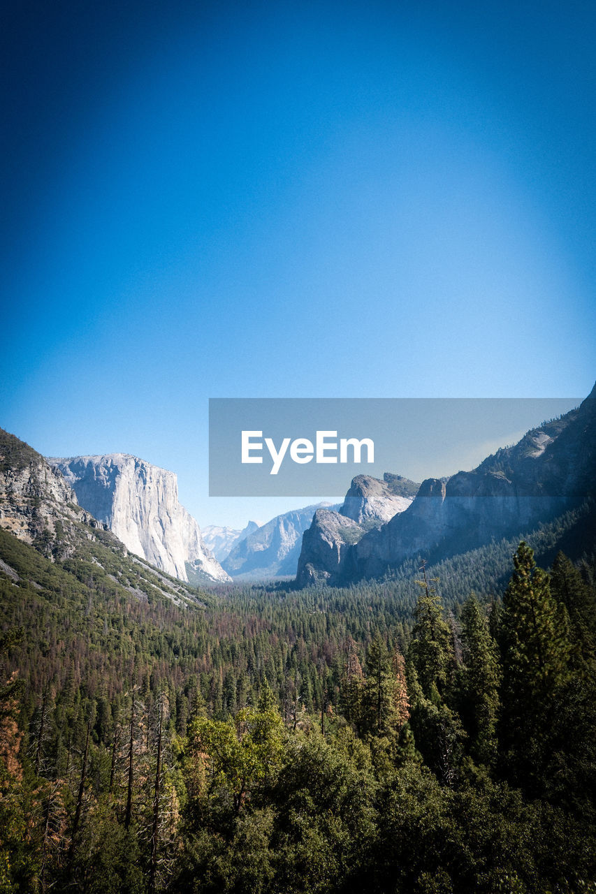 Scenic view of mountains against clear blue sky