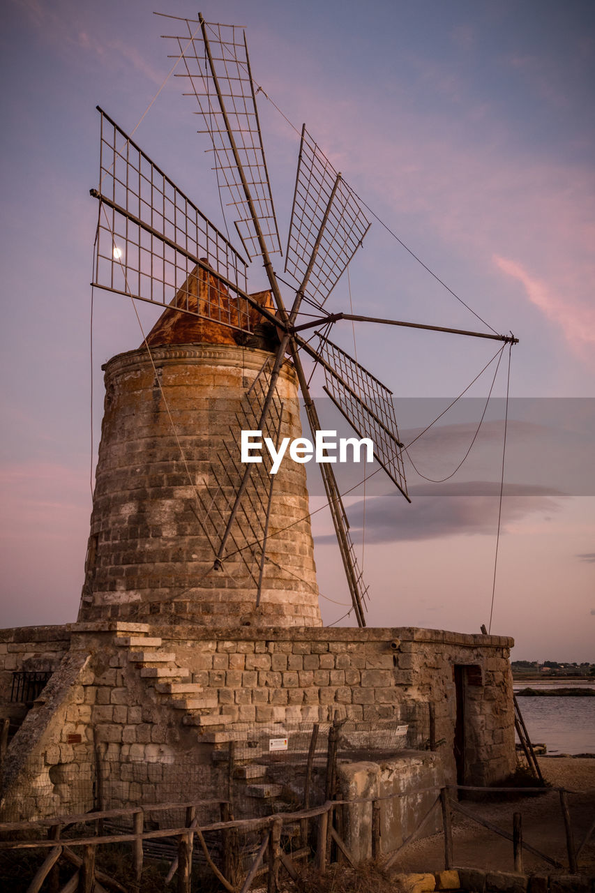 LOW ANGLE VIEW OF TRADITIONAL WINDMILL AGAINST SKY