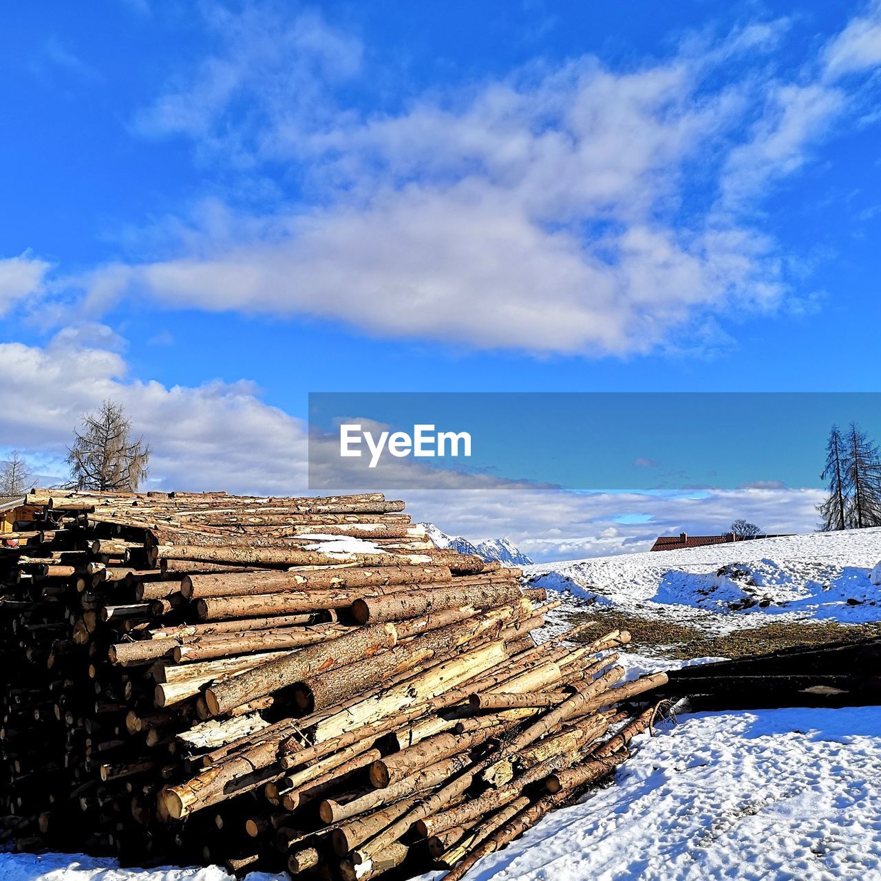 AERIAL VIEW OF SNOWCAPPED FIELD AGAINST SKY