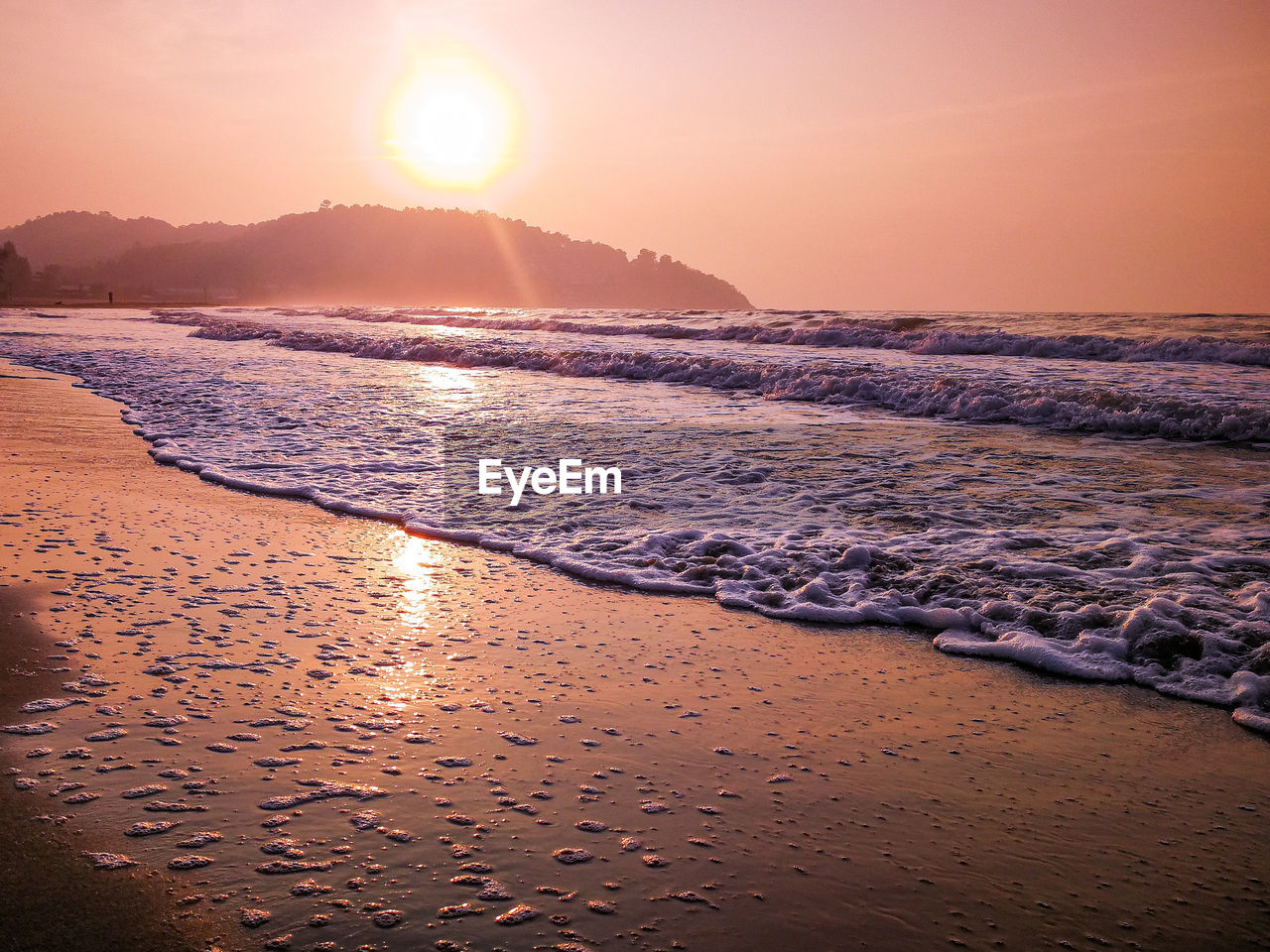 SCENIC VIEW OF BEACH AGAINST SKY AT SUNSET