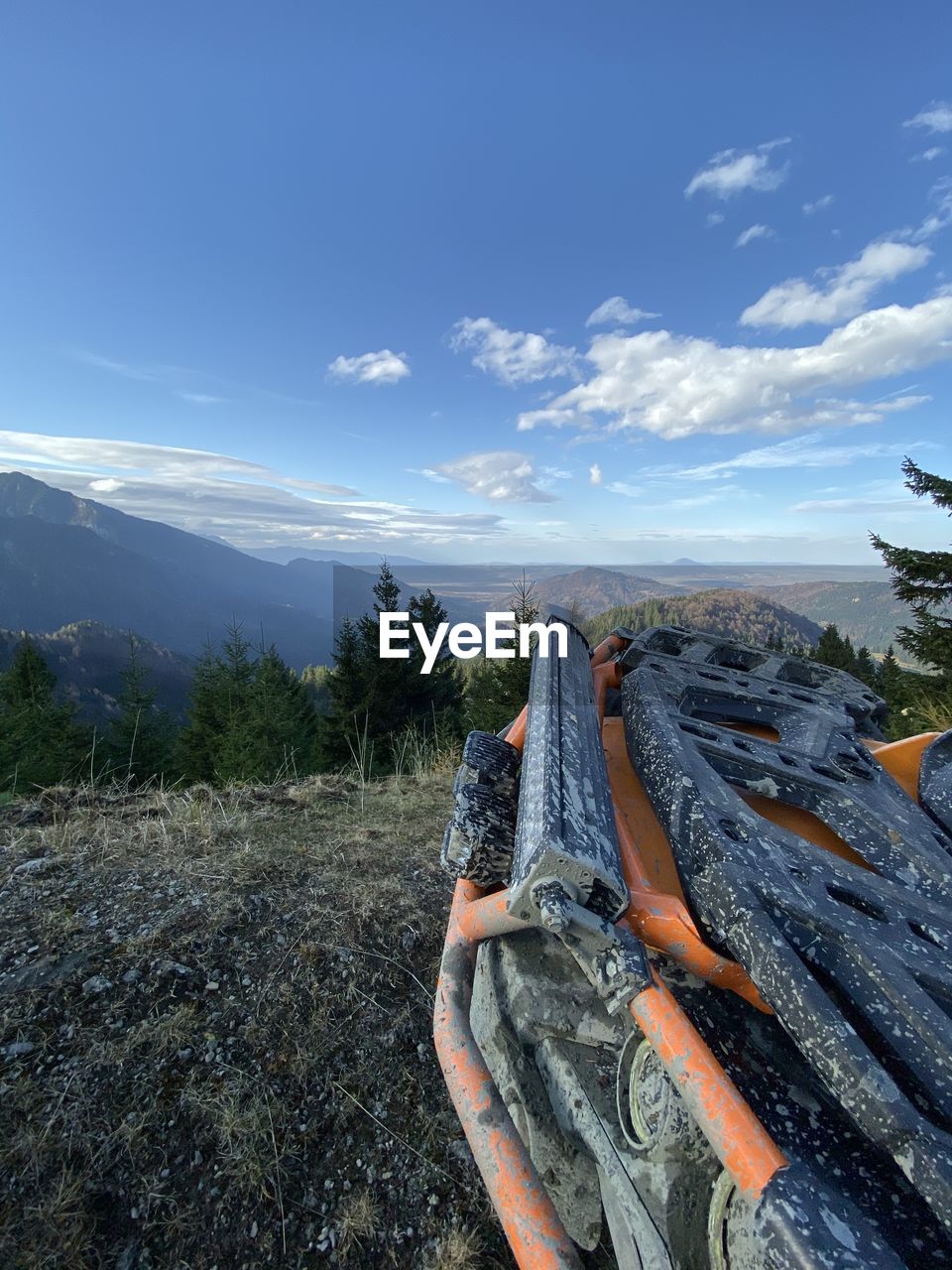 MAN ON MOUNTAIN AGAINST SKY