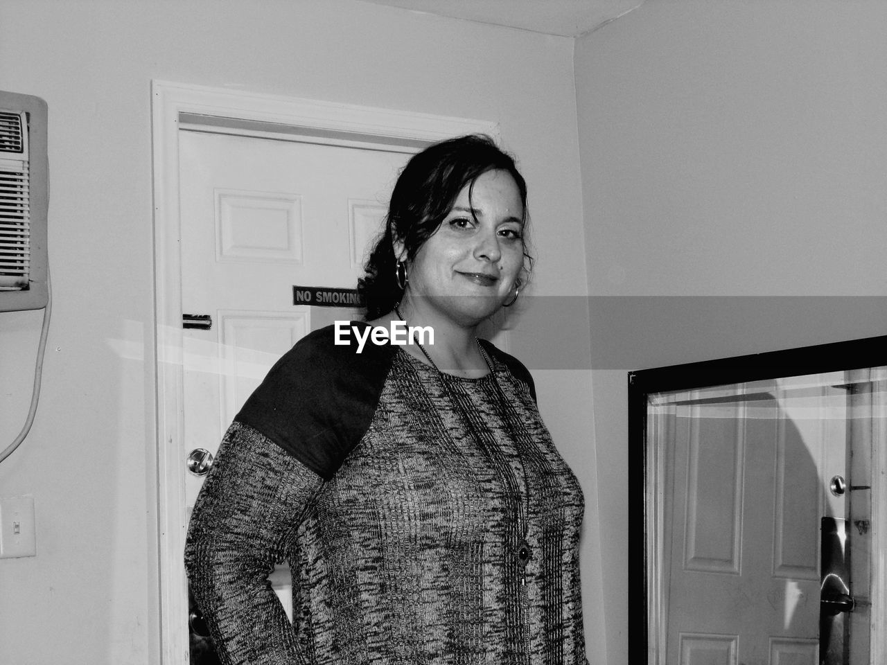 Portrait of smiling woman standing at home