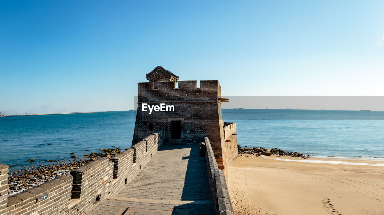 BUILT STRUCTURE ON BEACH AGAINST CLEAR SKY