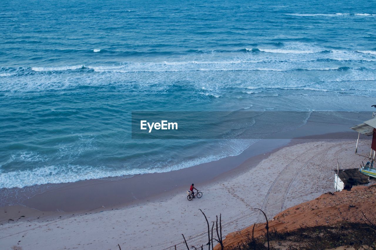 High angle view of man with bicycle at beach