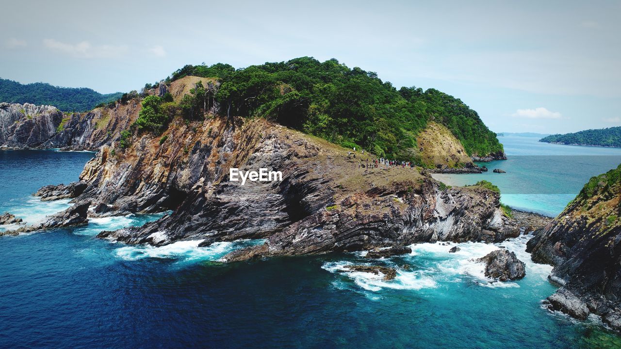 Rock formations in sea against sky