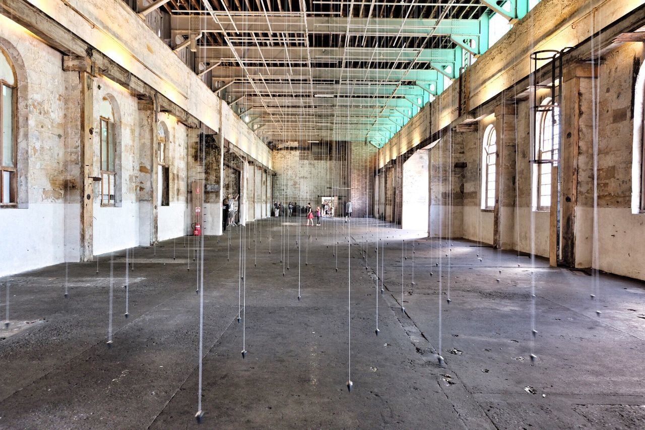 Plumb bobs hanging from ceiling in museum