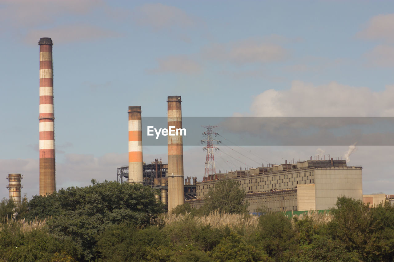 Low angle view of factory against sky