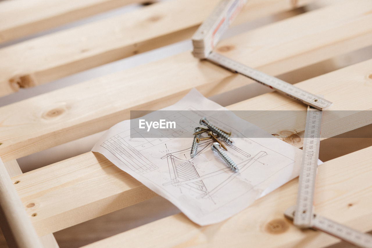 HIGH ANGLE VIEW OF PAPER AND TABLE ON FLOOR