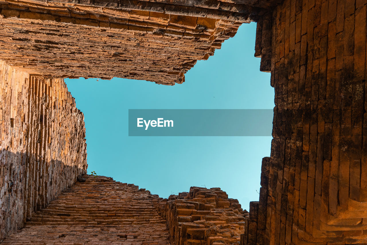 Low angle view of old ruin building against sky
