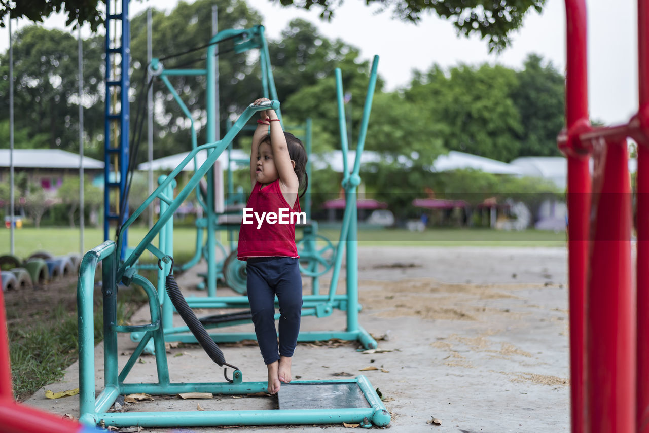 full length of boy swinging in playground