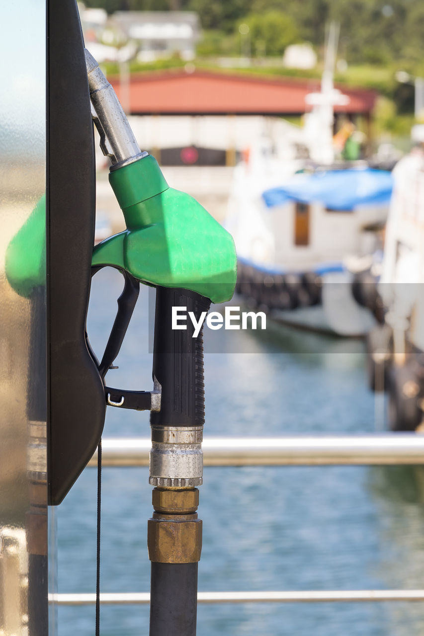 Close-up of fuel pump by sea