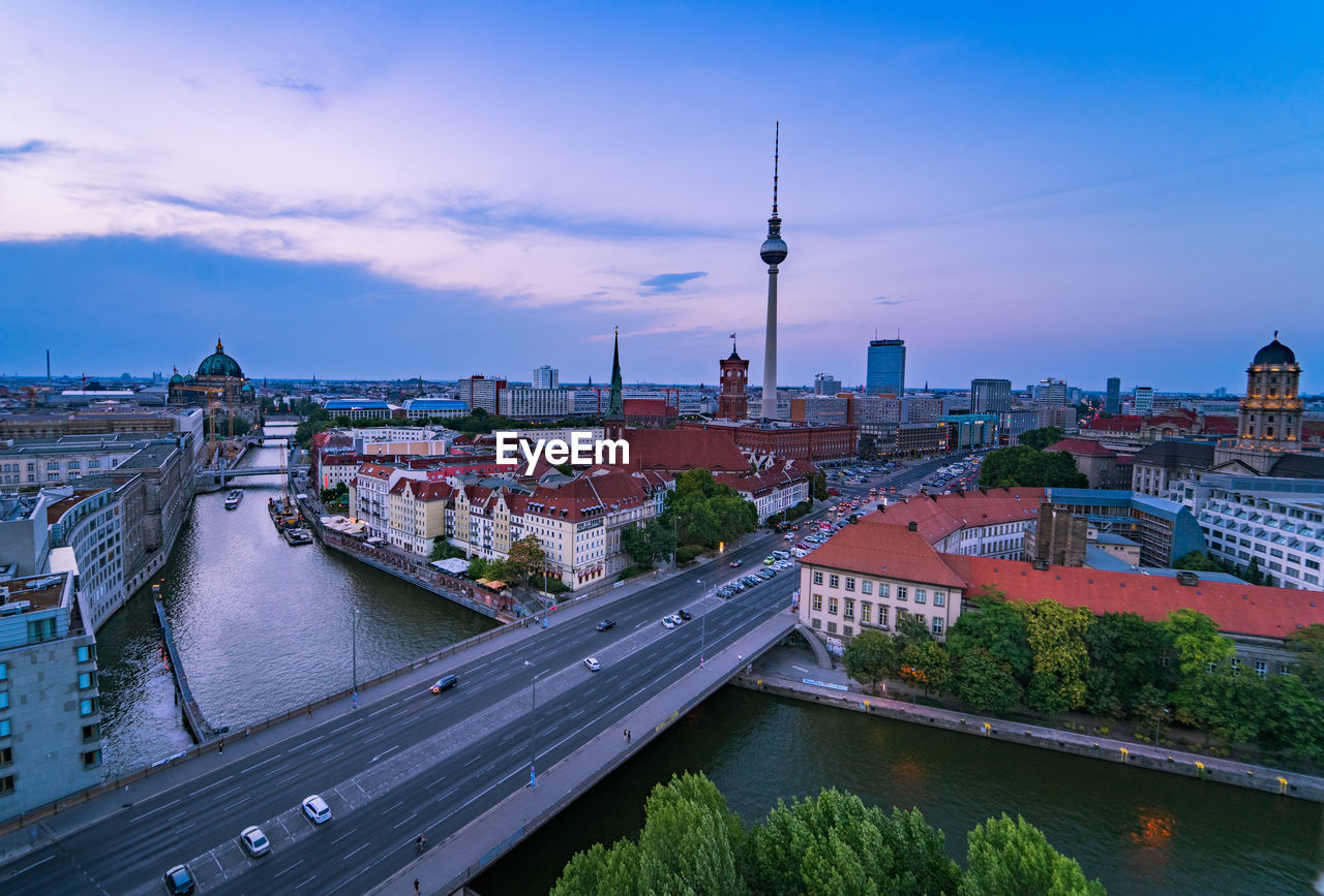 Bridge over river with buildings in background