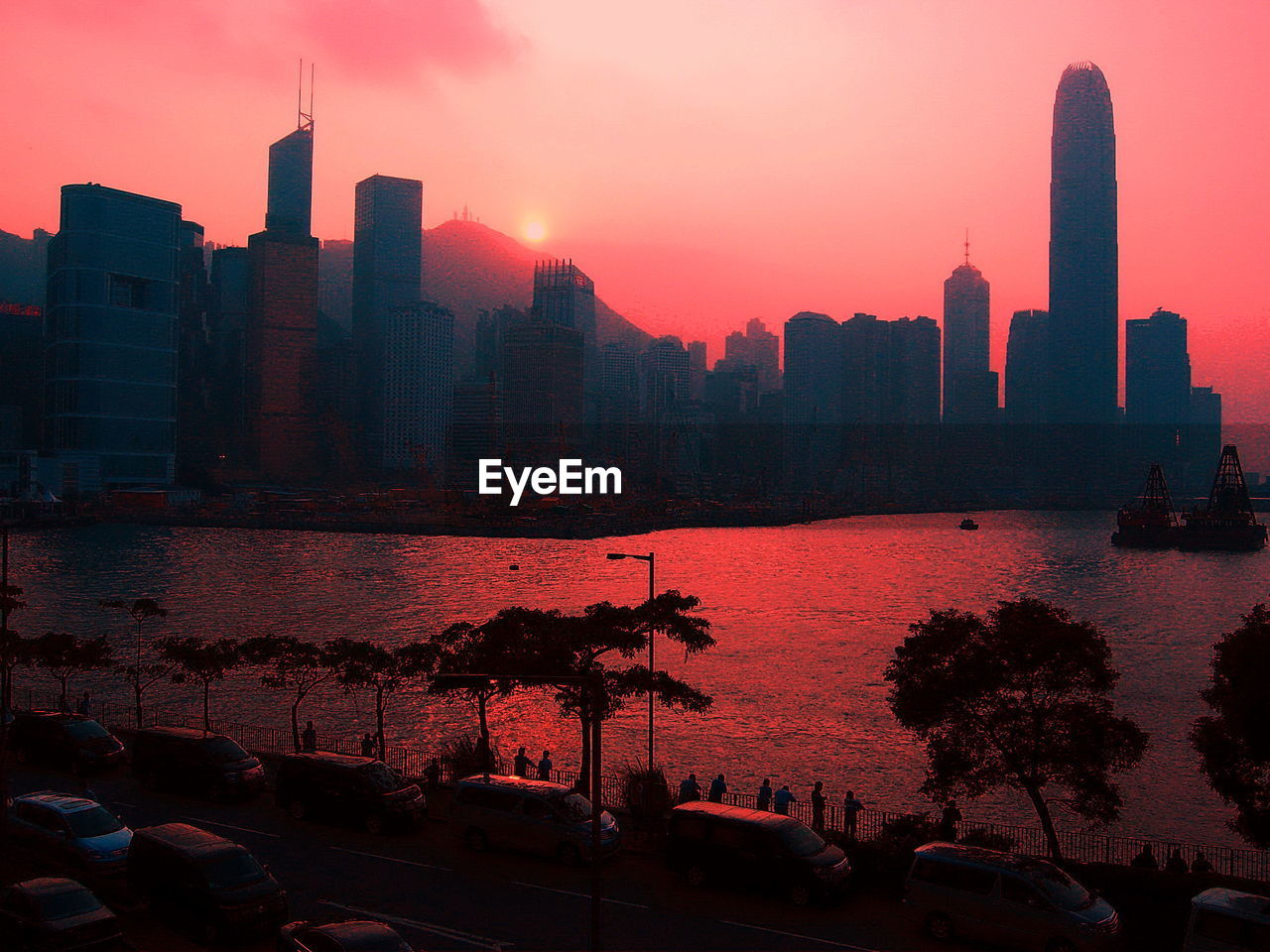 Silhouette of buildings at victoria harbour during sunset