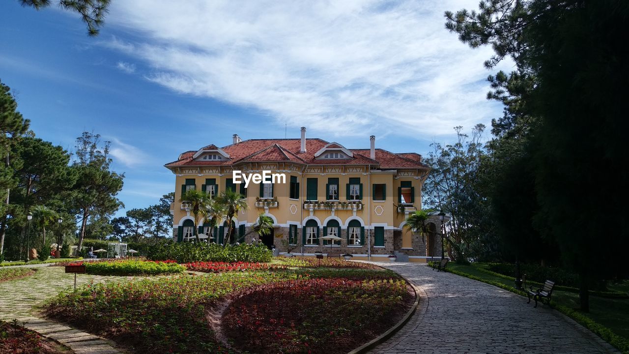 VIEW OF BUILDING WITH TREES IN BACKGROUND