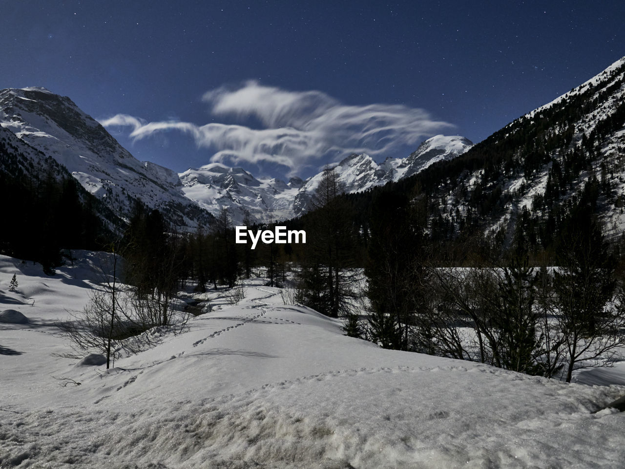 Scenic view of snow covered mountains against sky