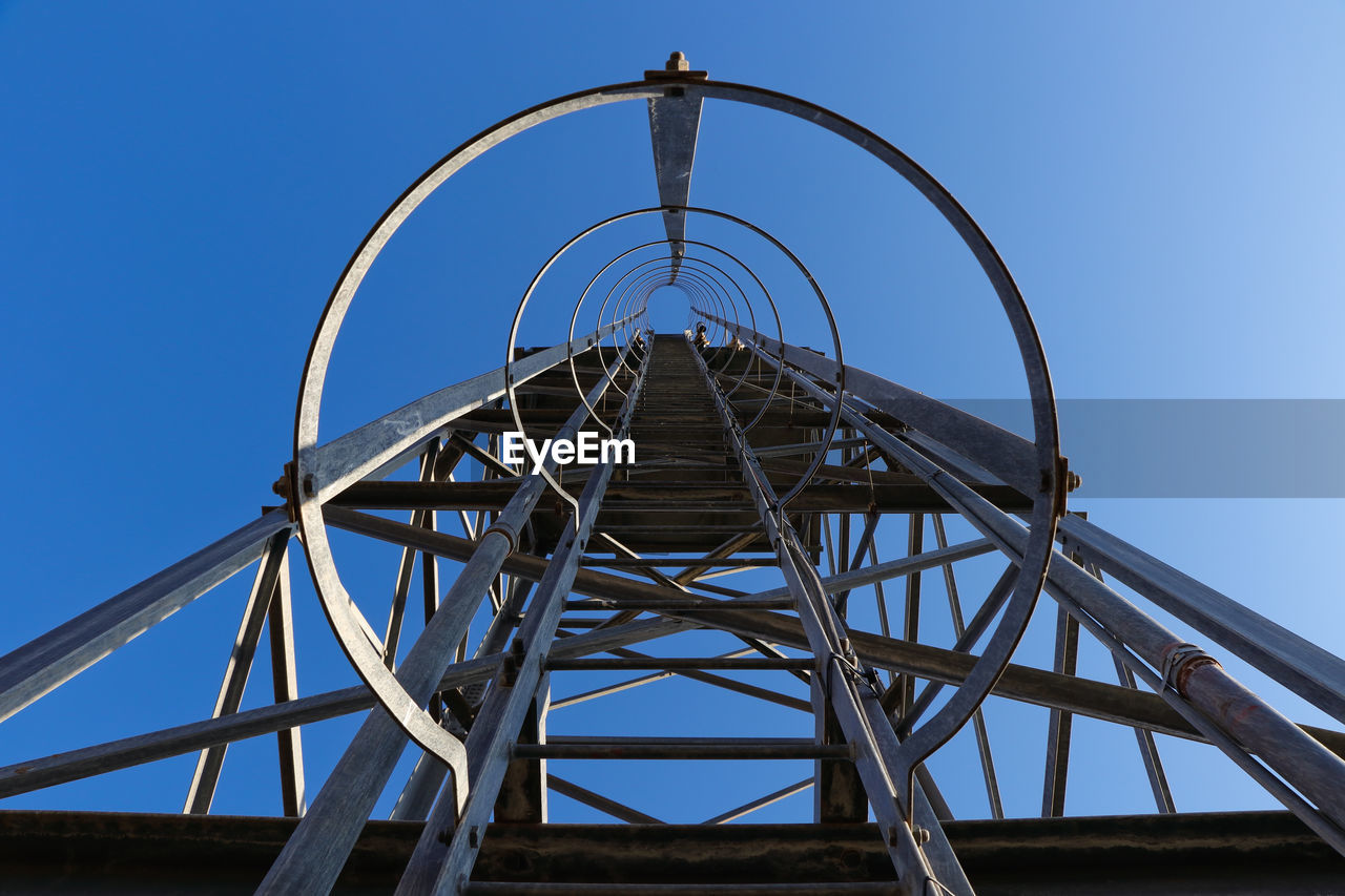 LOW ANGLE VIEW OF METALLIC STRUCTURE AGAINST SKY