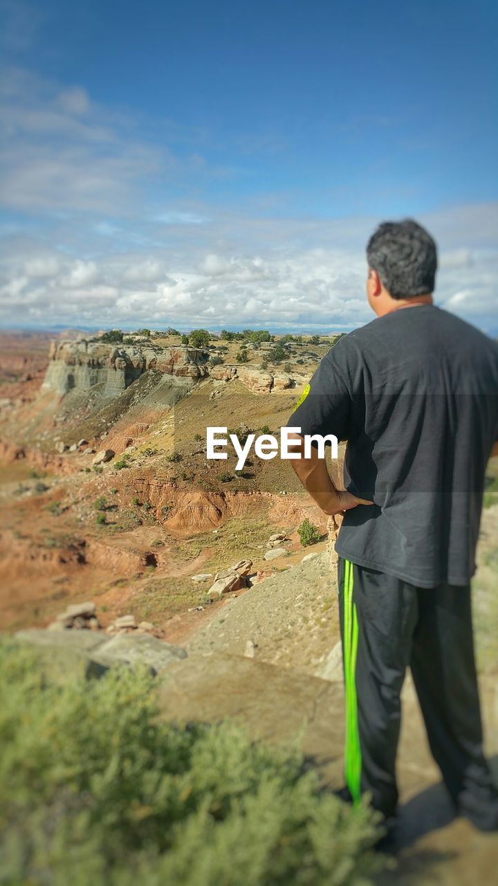 WOMAN STANDING ON LANDSCAPE