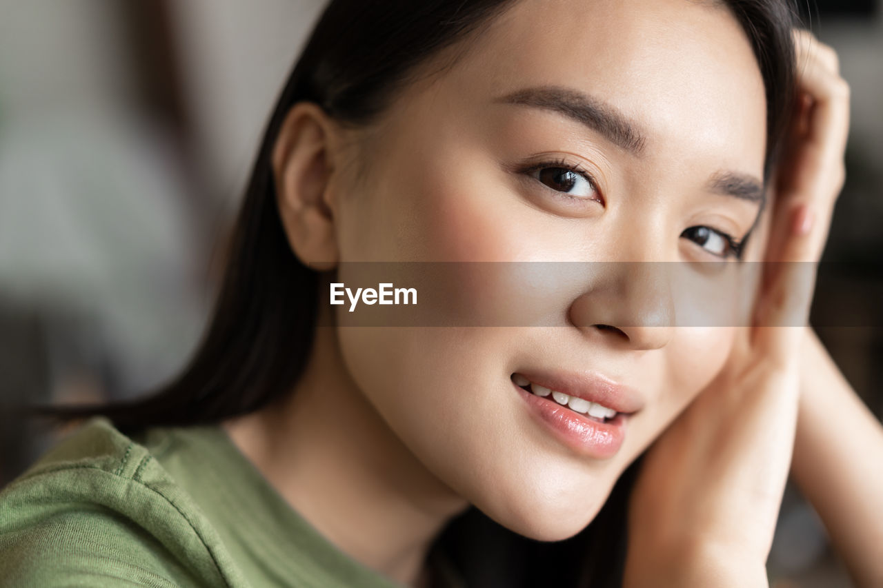 close-up portrait of young woman at home