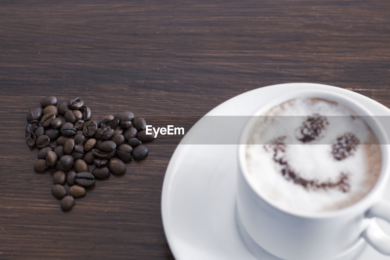 HIGH ANGLE VIEW OF COFFEE BEANS IN CONTAINER ON TABLE