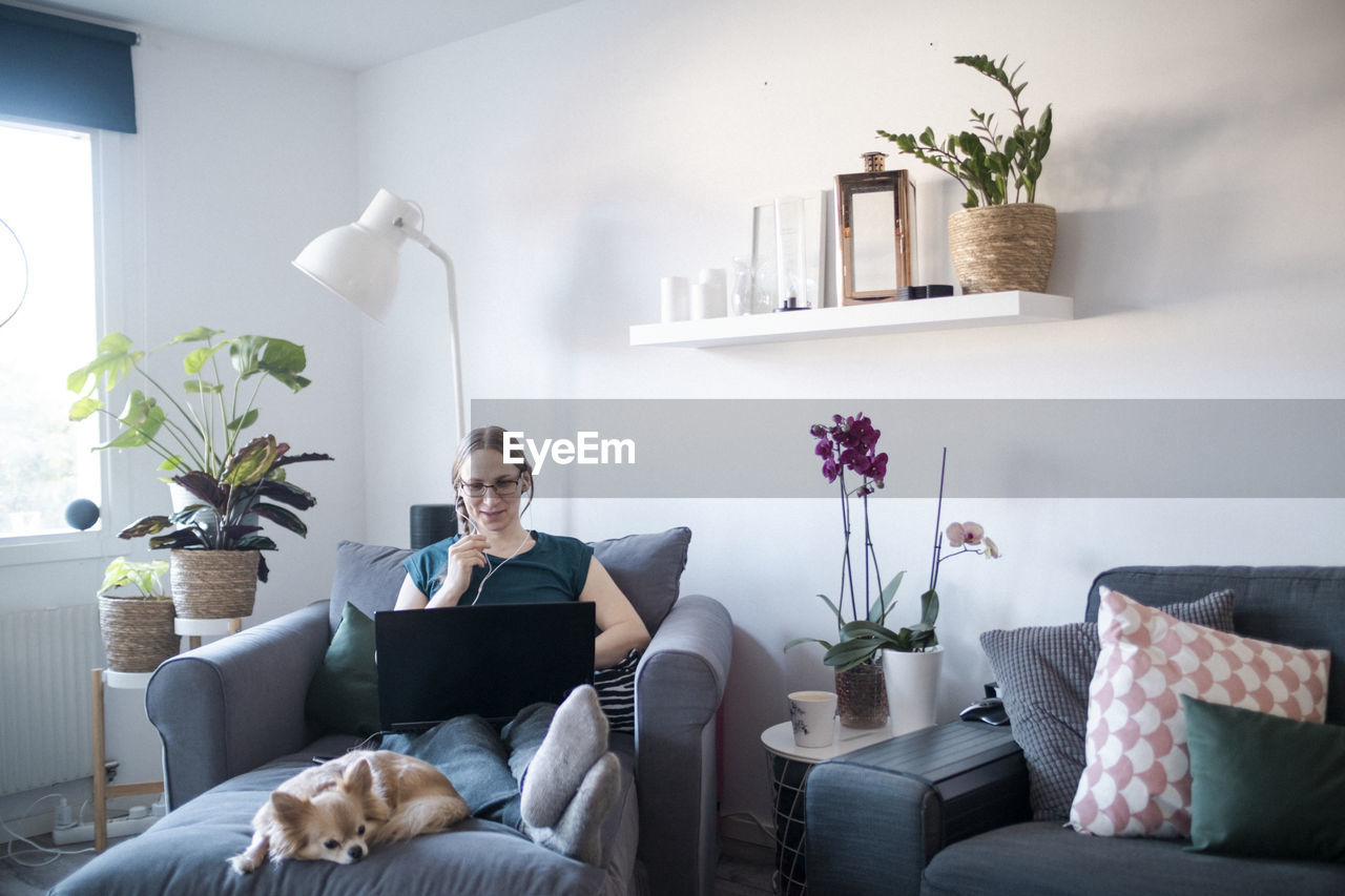 Woman in living room using laptop