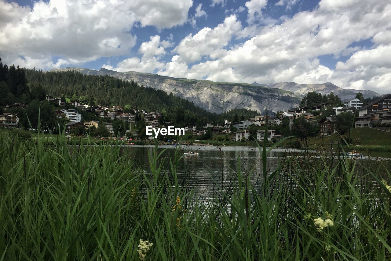 Scenic view of green landscape and mountains against sky