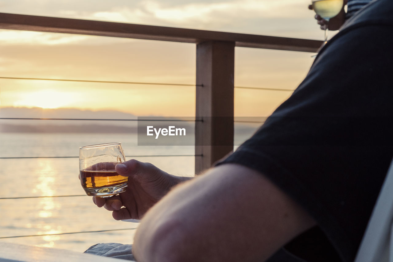 Close-up of man drinking whiskey