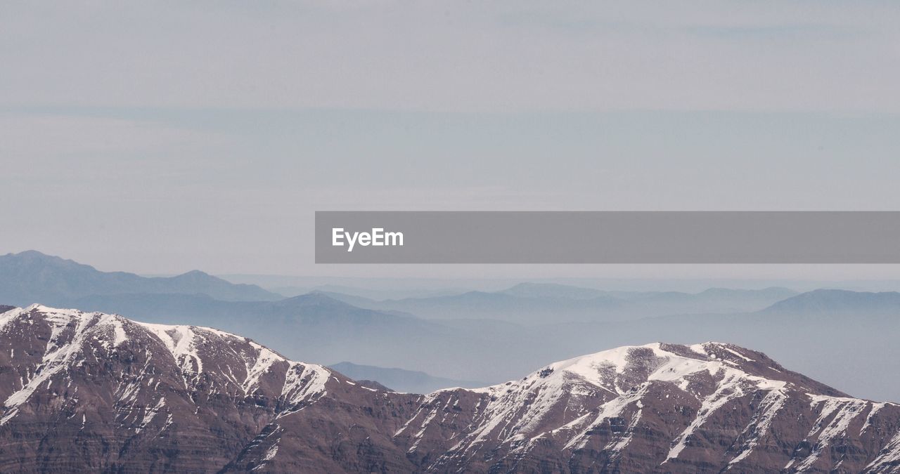 PANORAMIC VIEW OF SNOWCAPPED MOUNTAINS AGAINST SKY