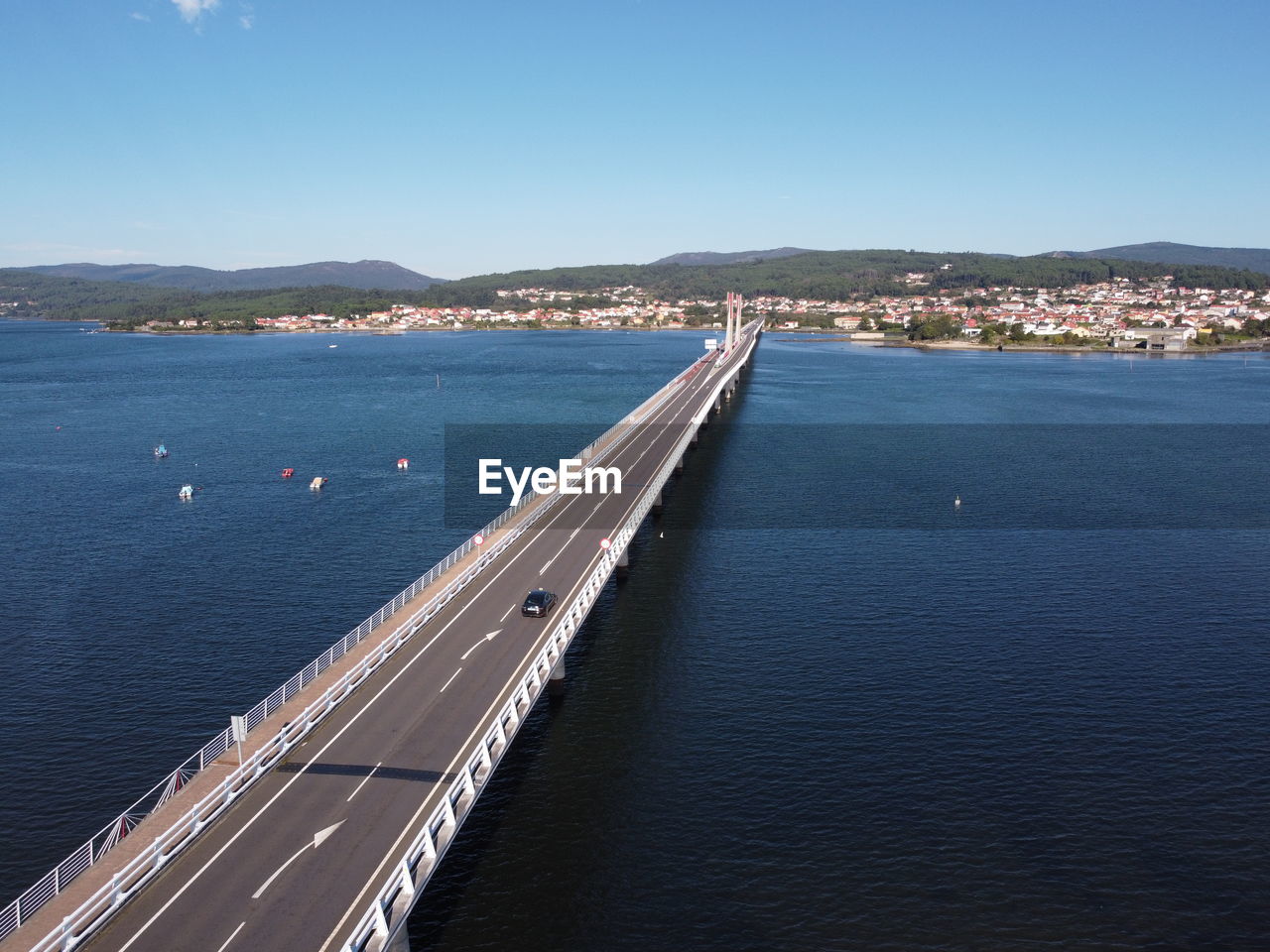 HIGH ANGLE VIEW OF CITY BY SEA AGAINST SKY