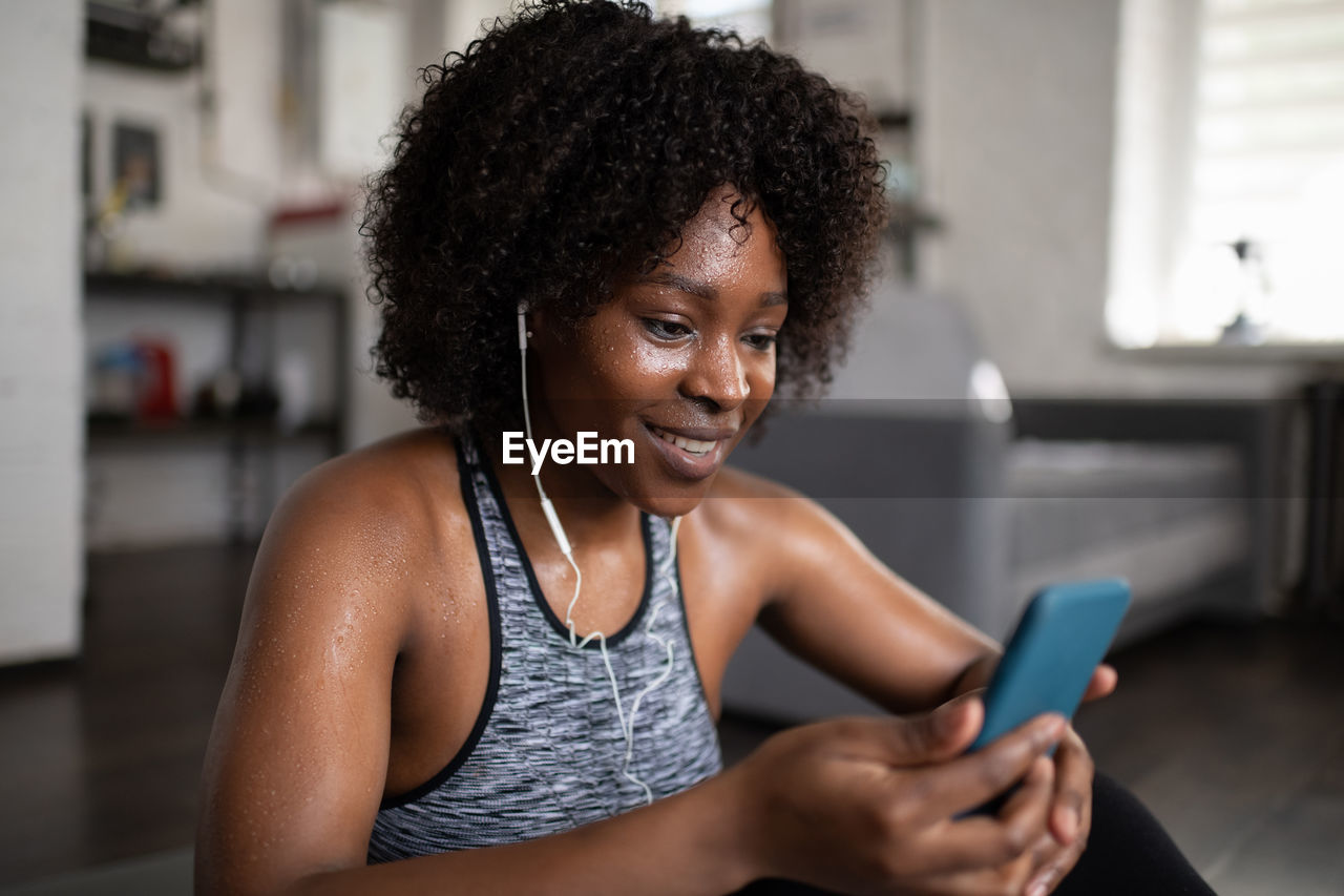 Sweaty black woman listening to music