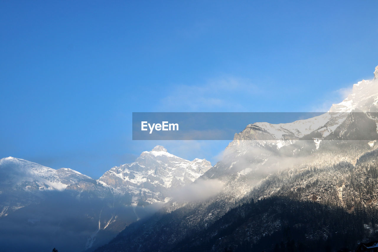SNOWCAPPED MOUNTAIN AGAINST BLUE SKY