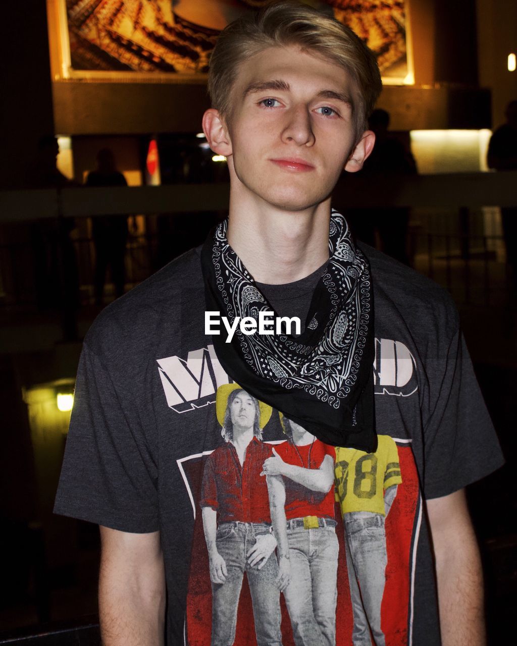 Portrait of young man standing in darkroom