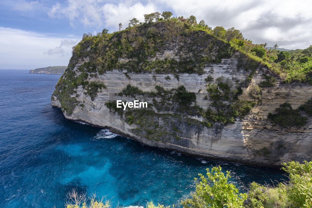 SCENIC VIEW OF SEA AGAINST ROCK FORMATION