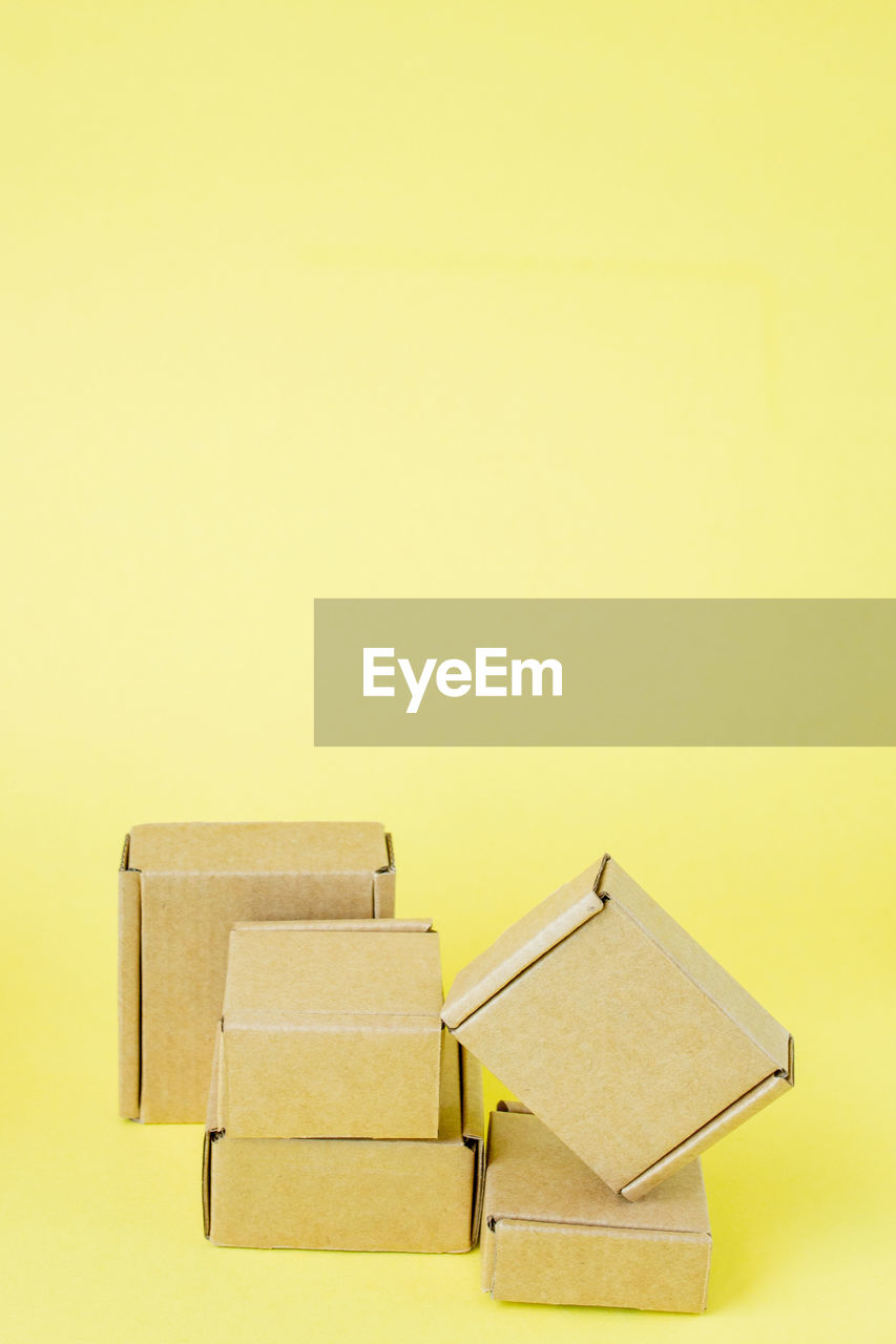copy space, yellow, studio shot, colored background, indoors, no people, yellow background, lighting, wood, paper, business, still life