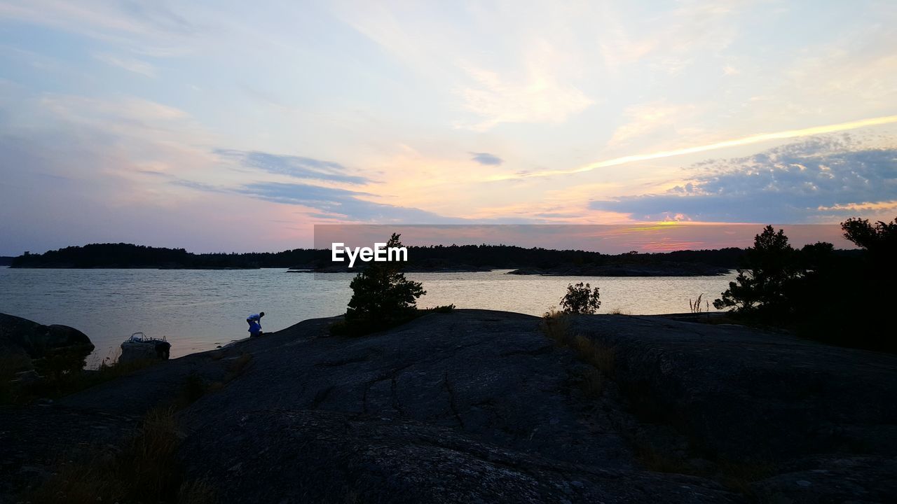 Scenic view of lake against sky during sunset