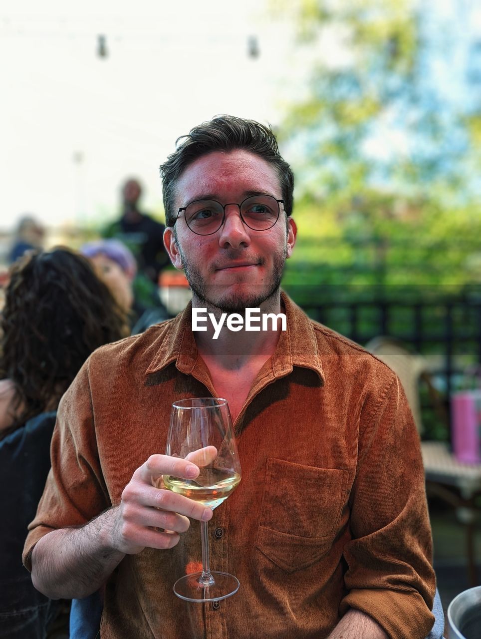 Portrait of young man drinking wine