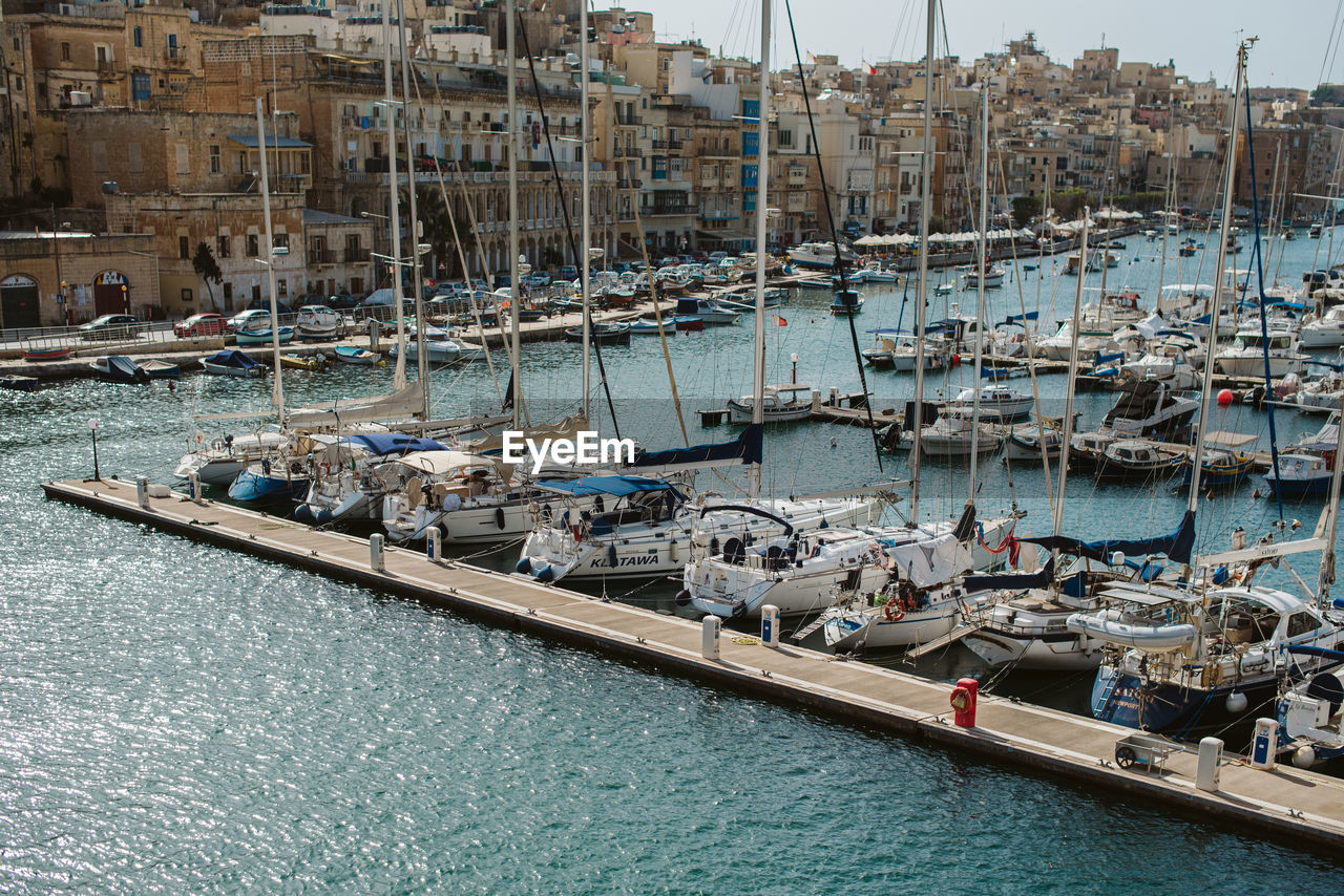 BOATS MOORED IN HARBOR