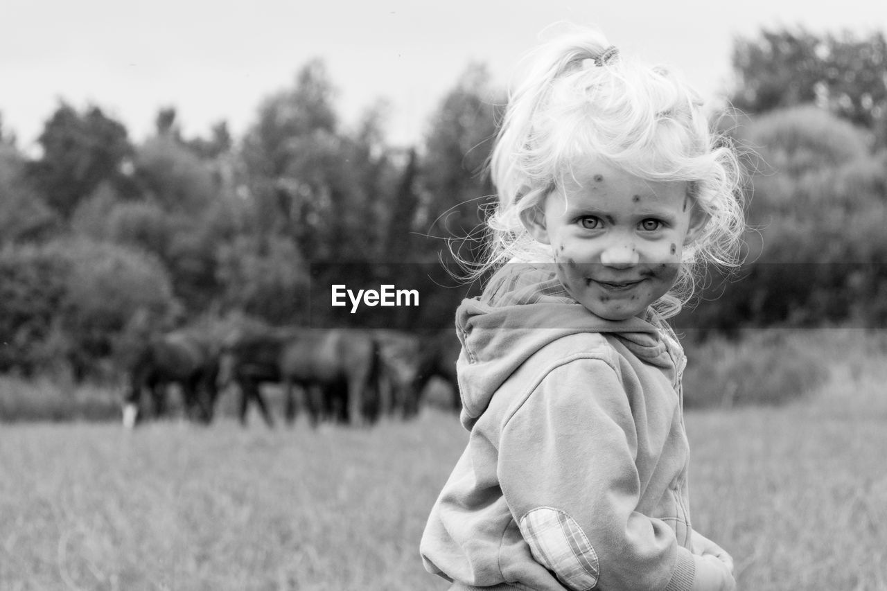 Portrait of smiling girl on field