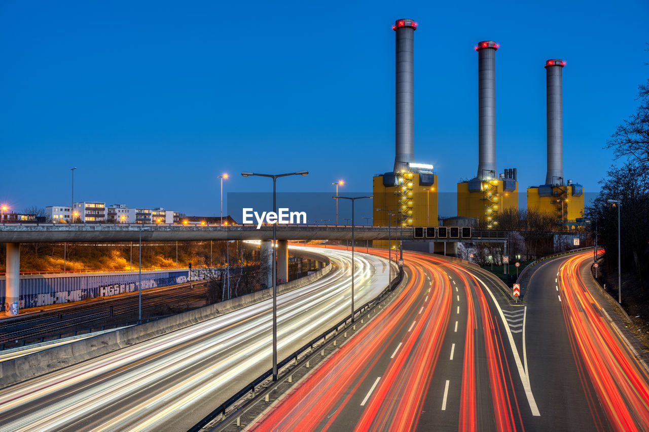 Highway and  power station at night seen in berlin, germany