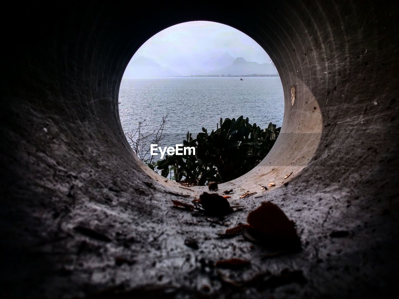 Scenic view of sea seen through hole