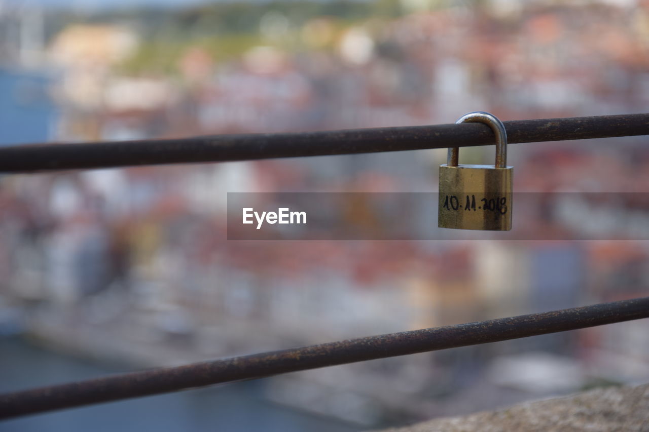 CLOSE-UP OF PADLOCK ON RAILING