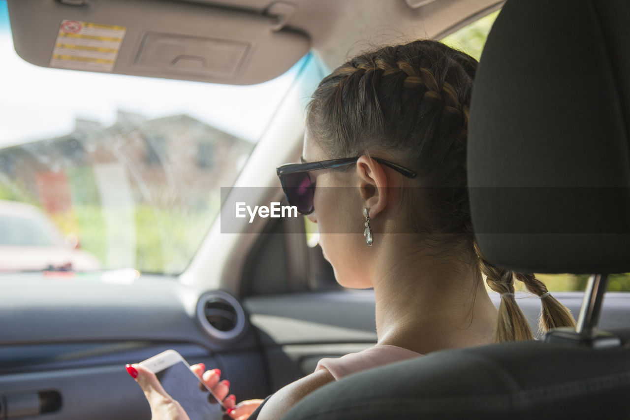 WOMAN SITTING IN CAR