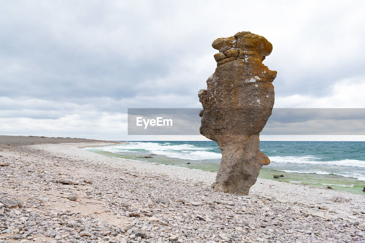 sea, land, rock, water, beach, sand, sky, cloud, shore, coast, nature, ocean, body of water, beauty in nature, scenics - nature, day, vacation, environment, horizon, horizon over water, tranquility, travel destinations, no people, travel, outdoors, statue, wave, landscape, tranquil scene, motion, holiday, cliff, sculpture
