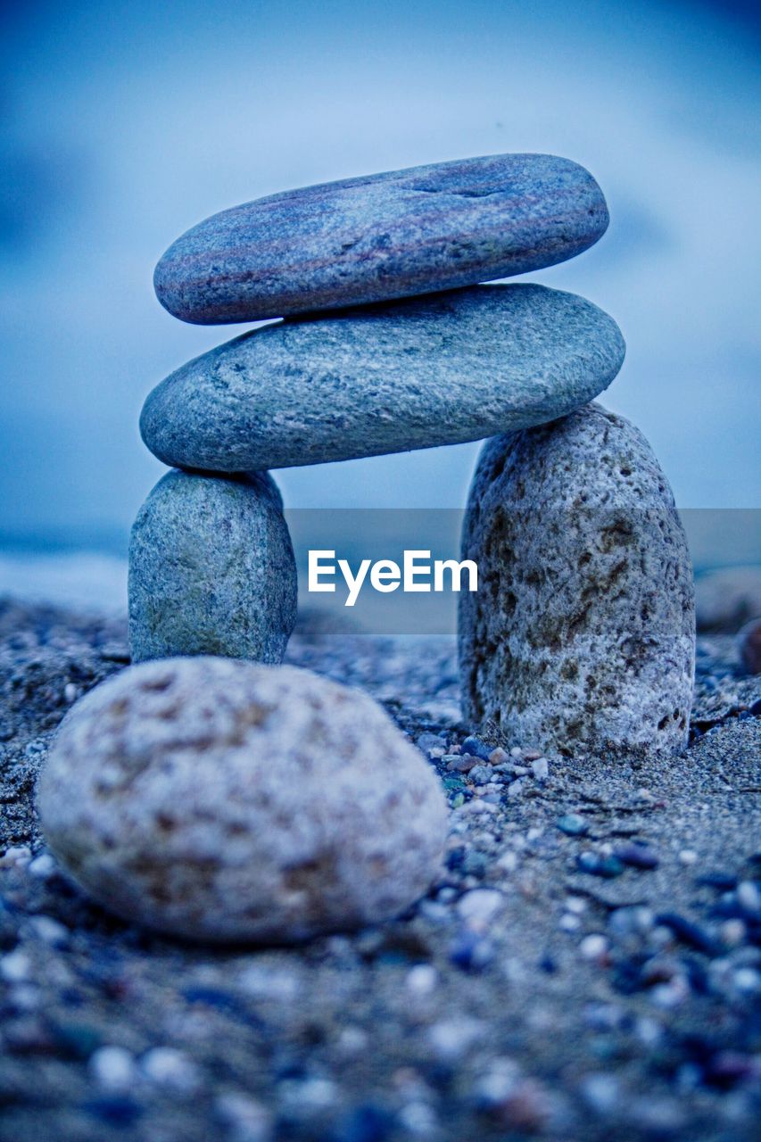 Stack of stones on sand at beach