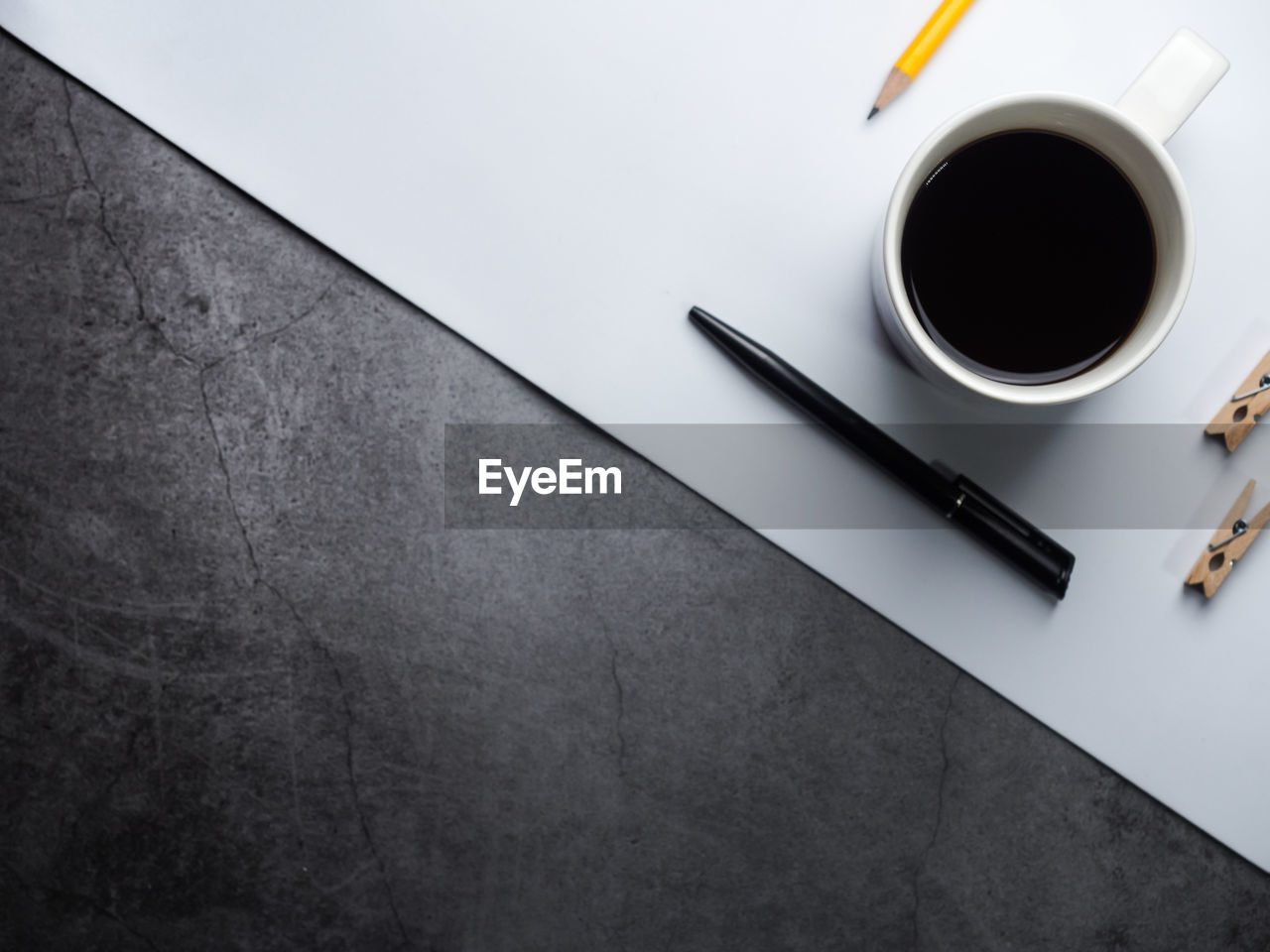 HIGH ANGLE VIEW OF COFFEE CUP ON TABLE WITH BLACK BACKGROUND