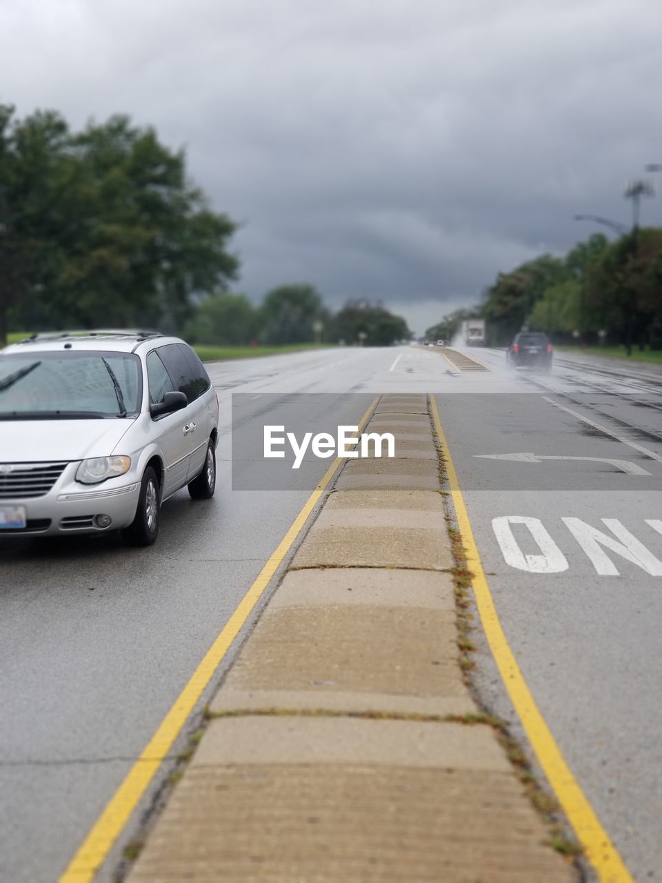 CAR ON ROAD AGAINST SKY